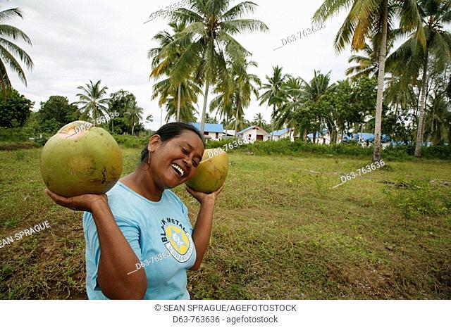 INDONESIA  CRS housing project at Seunebok Tuengoh relocation site  Woman with coconuts  Meulaboh, Aceh, two years after the Tsunami