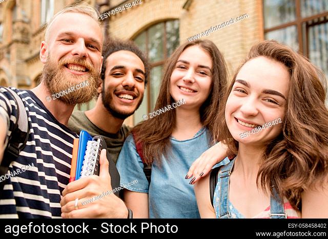 Selfie photo of young college students. Smiling faces of young boys and girls