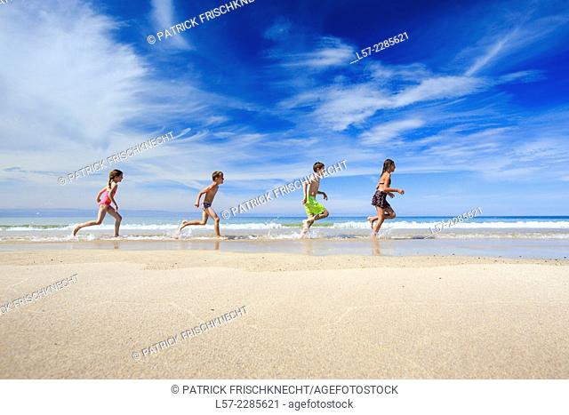 children running along sandy beach, Scotland