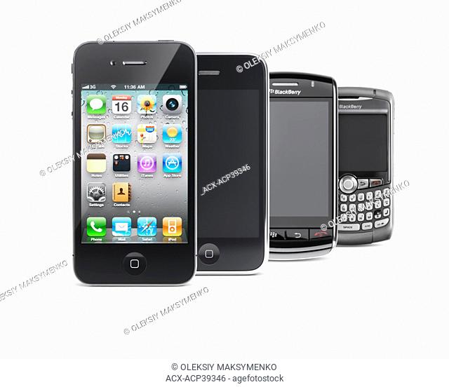 Four smartphones isolated on white background. Apple iPhone 4, iPhone 3G, Blackberry Storm and Blackberry Curve