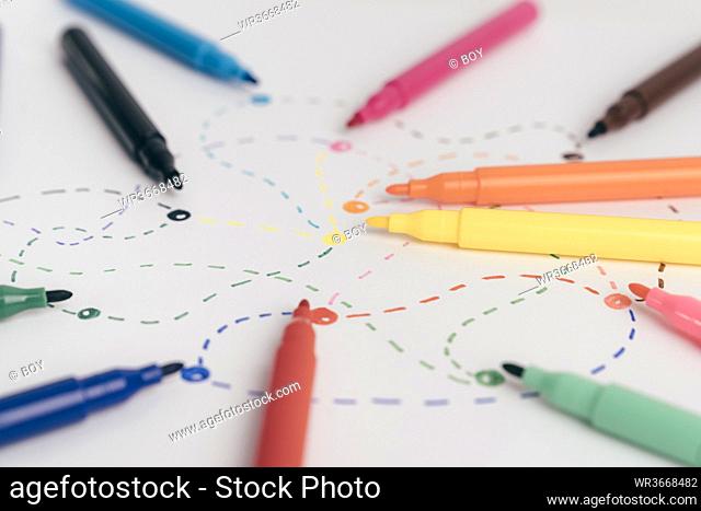 Colorful felt tip pens connected with dotted lines