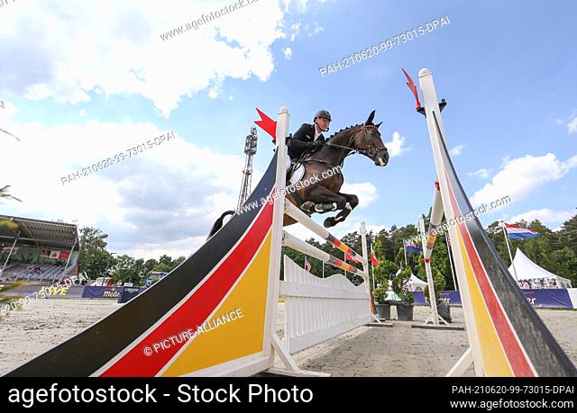 20 June 2021, Lower Saxony, Luhmühlen: Equestrian sport: German Championship, Eventing. The German event rider Andreas Dibowski rides FRH Corrida in the jumping...