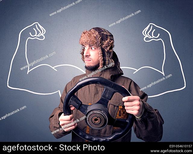 Young man holding black steering wheel with muscly arms drawn next to him