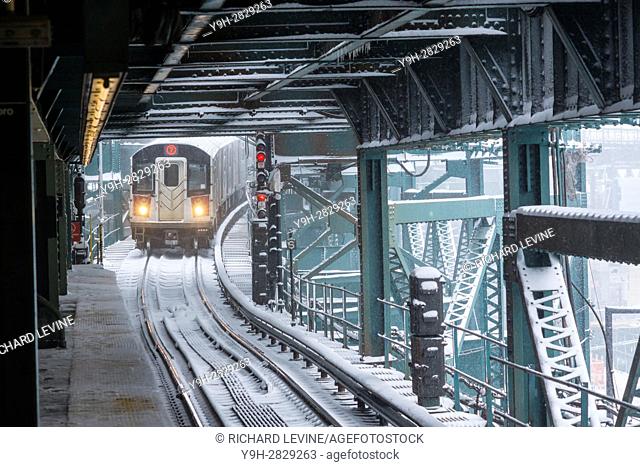 A Flushing Line train arrives at the Queensboro Plaza station in New York during the city's first major winter storm of the season