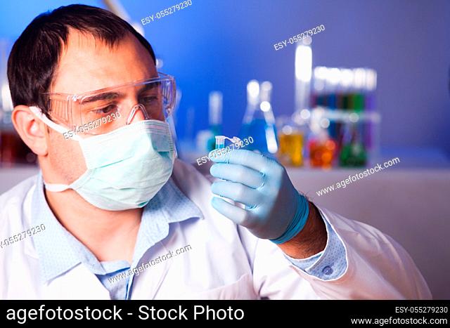 Scientist is thinking about research and hold eppendorf tube