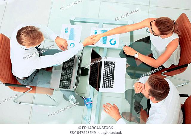 Image of business partners discussing ideas and working on laptops at meeting