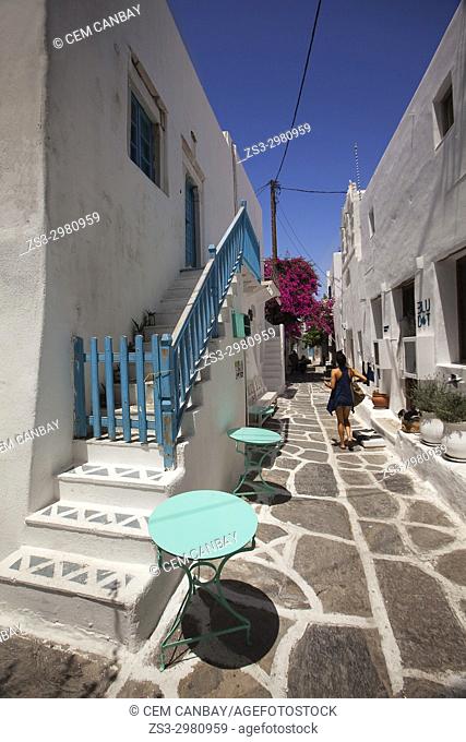 Woman walking in the alleys of the town center, Naoussa, Paros, Cyclades Islands, Greek Islands, Greece, Europe