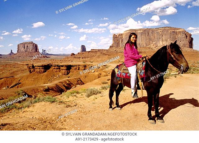 Young navajo female riding her horse by John Ford's point. Monument valley, Navajo reservation. Utah. United states (USA)