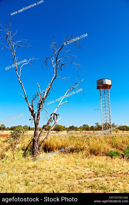 in australia the concept of remote in the outback with asphalt line and water tank