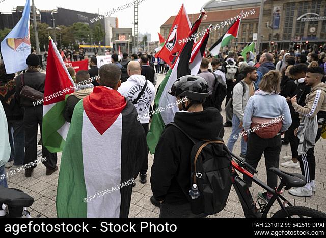 12 October 2023, Saxony, Leipzig: Participants of a rally in the center of Leipzig carry Palestinian flags. The rally takes place under the slogan ""Palestine -...