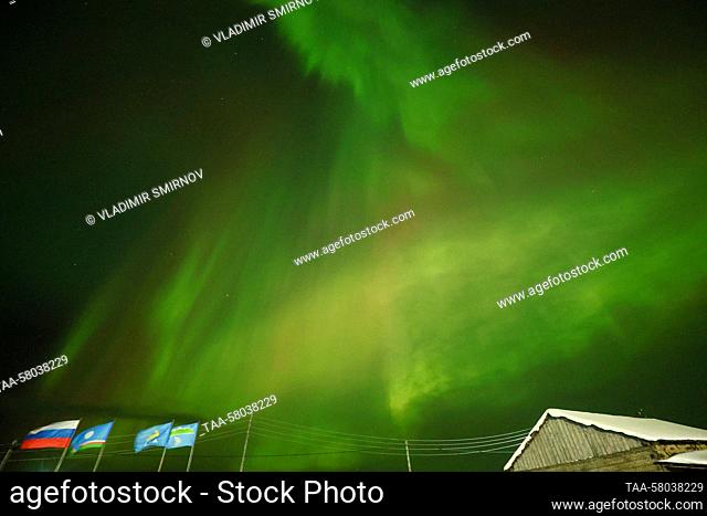 RUSSIA, REPUBLIC OF SAKHA (YAKUTIA) - MARCH 23, 2023: The Northern Lights, or the Aurora Borealis, shine over the village of Dzhargalakh in the...