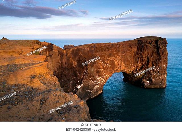 Beautiful summer landscape with rocky cape and ocean. Southern coast of Iceland. View of peninsula Dyrholaey, not far from the village Vík