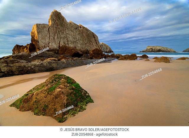 Huge rock cliffs, protect this small beach Liencres Cantabria, the usual storms with which the Cantabrian Sea hits the coast, call La Costa Quebrada