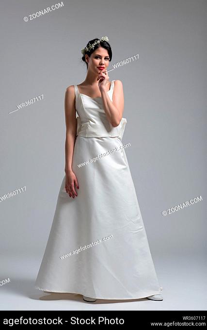 Portrait of beautiful young women in wedding dress isolated on a white background
