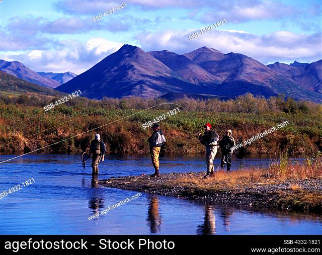 Jim Jordan and Eric Young catching fish simultaneously while fly fishing on Igmiumanik Creek in the Ahklun Mountains above Goodnews Lake