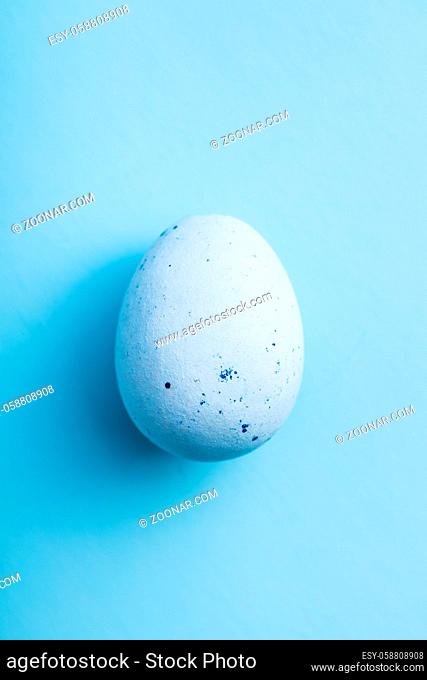 Blue chocolate easter egg. Sweet candy egg on a blue background. Top view