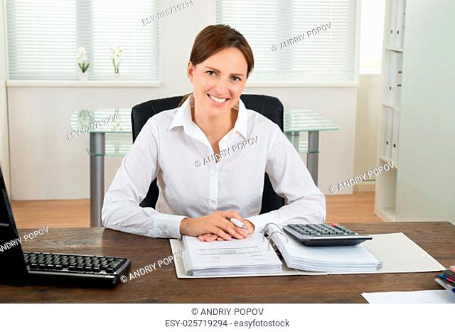 Photo Of Happy Businesswoman Calculating Invoice At Desk