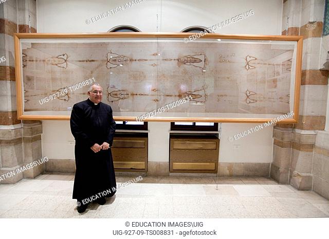 Roman Catholic Father with Shroud of Turin replica in the Notre Dame de France Hospice, Jerusalem, Israel