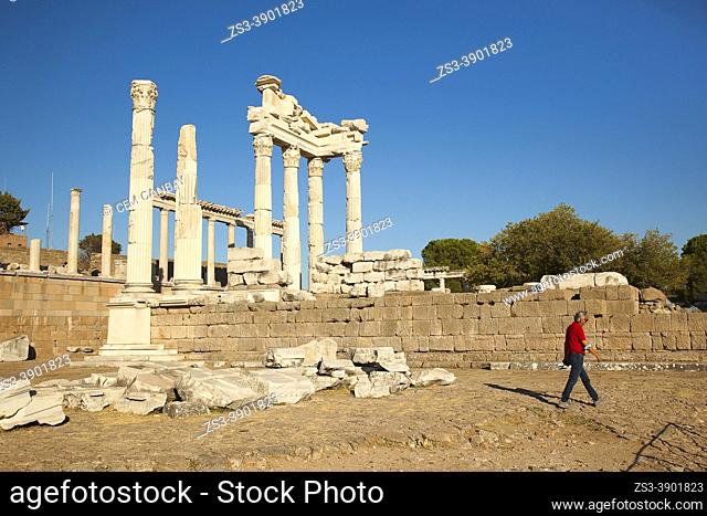 Tourist in front of the marble columns and rests of The Sanctuary of Trajan at Bergama Archaeological site of ancient Pergamon city, Bergama Town