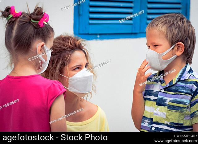 Family wearing facial disposable mask to avoid viral infection. Coronavirus protection