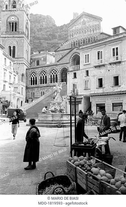 Apples, lemons, green beans, pineapples and other products at a banquet of the market in Piazza Duomo, in front of the Fountain of St