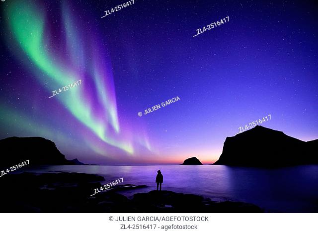 Norway, Nordland, Lofoten islands, Vestvagoy island, Vik beach, silhouette of a woman and northern lights (aurora borealis), Model Released