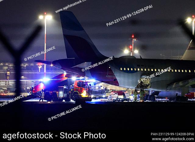 29 November 2023, Hamburg: A Eurowings aircraft is parked away from the terminals at Hamburg Airport and is being unloaded