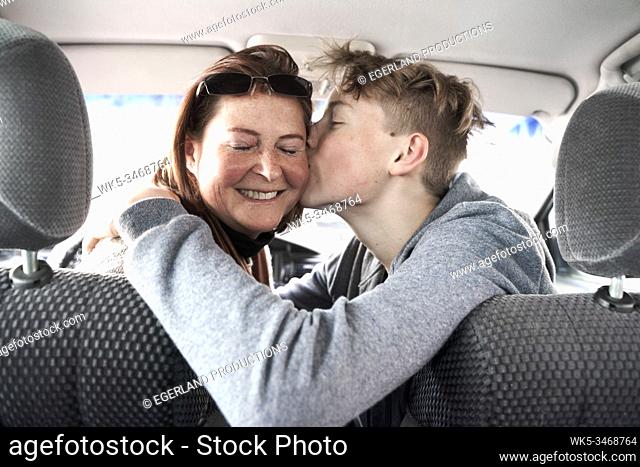 Teen boy with his mother in car, in Gaissach, Bavaria, Germany