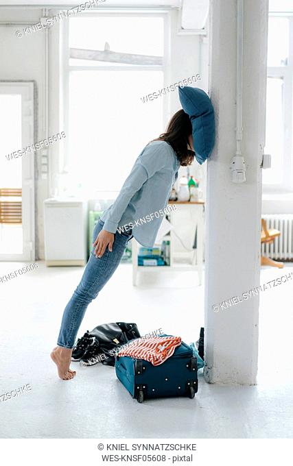 Jet-legged woman leaning on pillar