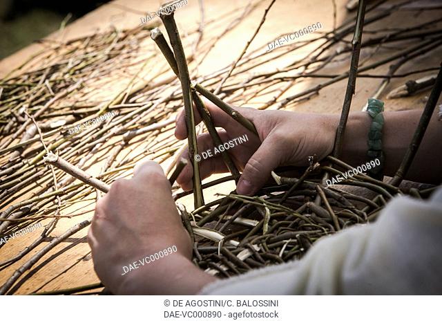 A Gallic woman weaving thin branches to make a basket. Celtic civilisation (Gauls), 4th-3rd century BC. Historical reenactment