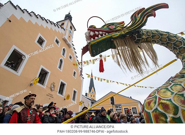 A group with a Chinese dragon attend the traditional carnival parade in Dietfurt, Germany, 8 February 2018. Every year fools walk through the village dressed as...