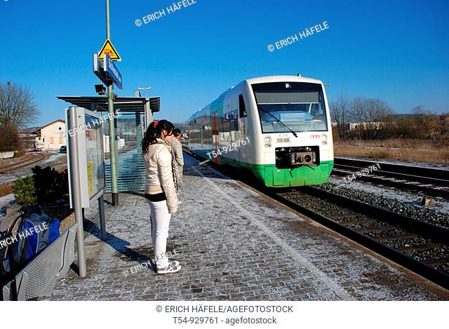 A Young Girl waiting for the Train in a Wintermorning