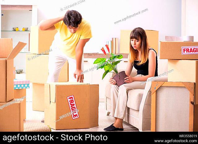 Young couple moving to new flat with fragile things