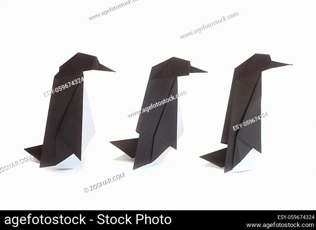 Three Origami Penguins Isolated On White