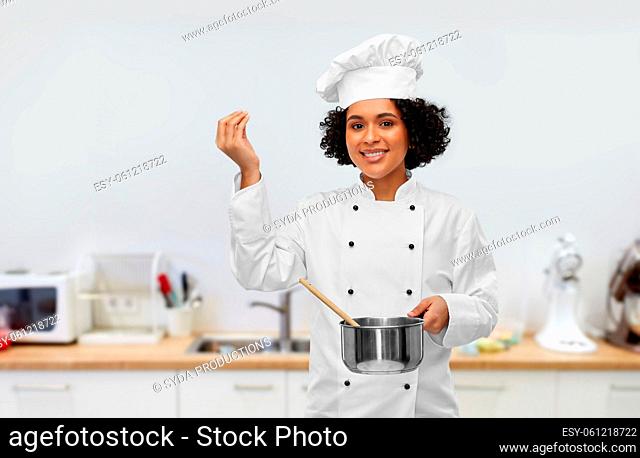 female chef with saucepan and spoon cooking food