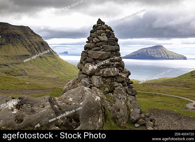 Faroe Island Koltur Island Sunset View Panorama from Nordredal Valley - Norðradalur towards the North Atlantic Ocean. Cairn - Pile of Stones on the top of the...