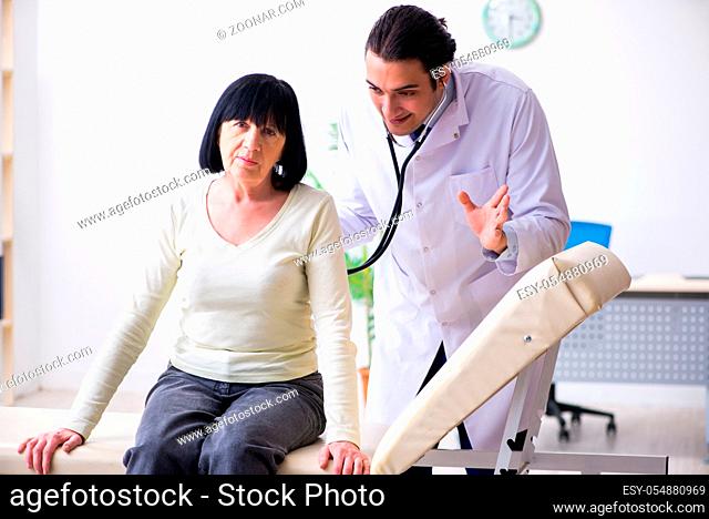 Young doctor examining senior old woman