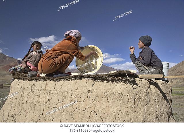 Kyrgyz herding family making kaiymak cheese in the Pshart Valley, Tajikistan