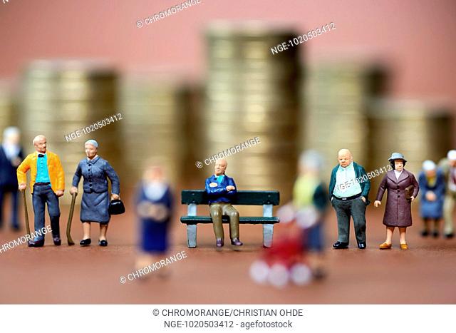 Miniature figures of elderly people and stacked euro coins, pension