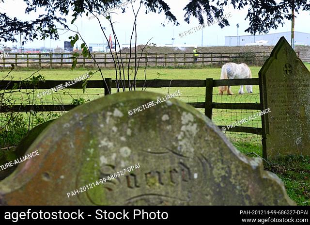 11 December 2020, Great Britain, Ashford: ""Sacred"" (holy) is written on a tombstone in the garden of the small 13th century Sevington Church in Ashford