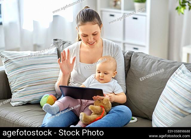 mother with baby having video call on tablet pc