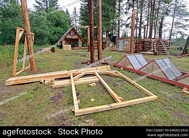 01 August 2023, Saxony-Anhalt, Elend: Wooden construction elements lie on a festival meadow in Elend . For the festival ""Rocken am Brocken"" , from 3