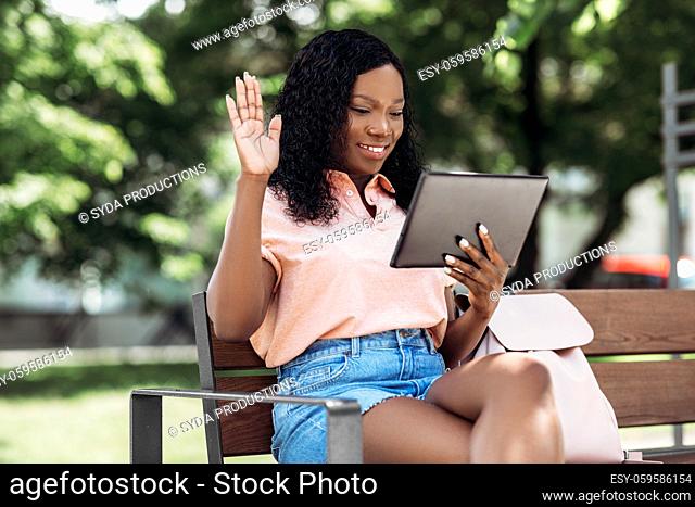 african woman with tablet pc having video call