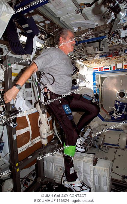 Astronaut John L. Phillips, Expedition 11 NASA Space Station science officer and flight engineer, uses the Cycle Ergometer with Vibration Isolation System...