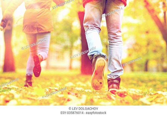 young couple running in autumn park
