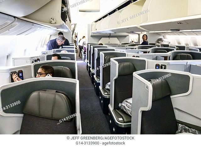 Florida, Miami, International Airport MIA, American onboard Airlines flight 56 business class seat seating cabin inside