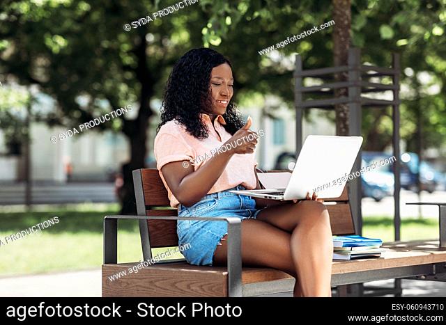 african student girl having video call on laptop
