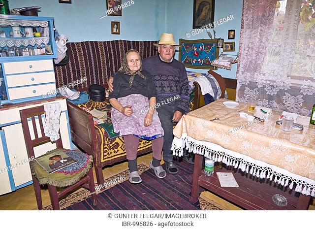 Romanian couple sitting in their living room in Bezded, Salaj, Transylvania, Romania, Europe