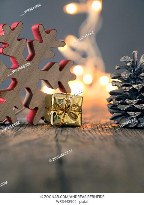 Merry Christmas background with wooden decoration and pine cone