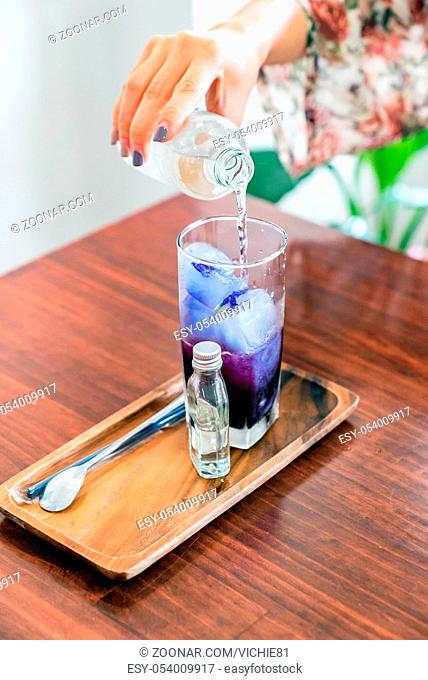 Butterfly pea ice cube server with soda water